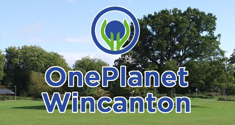 A background of blue skies, a green field and a cluster of tall trees. In the foreground the text reads 'One Planet Wincanton' with heir logo, two green hands surrounding a blue sphere that represents the earth.